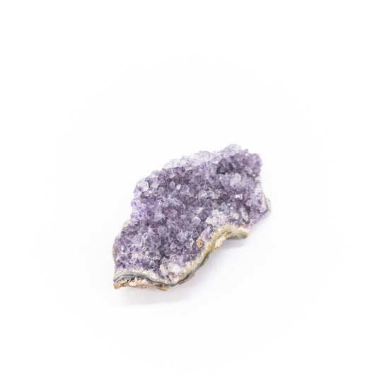 Amethyst crystal rock on a white background
