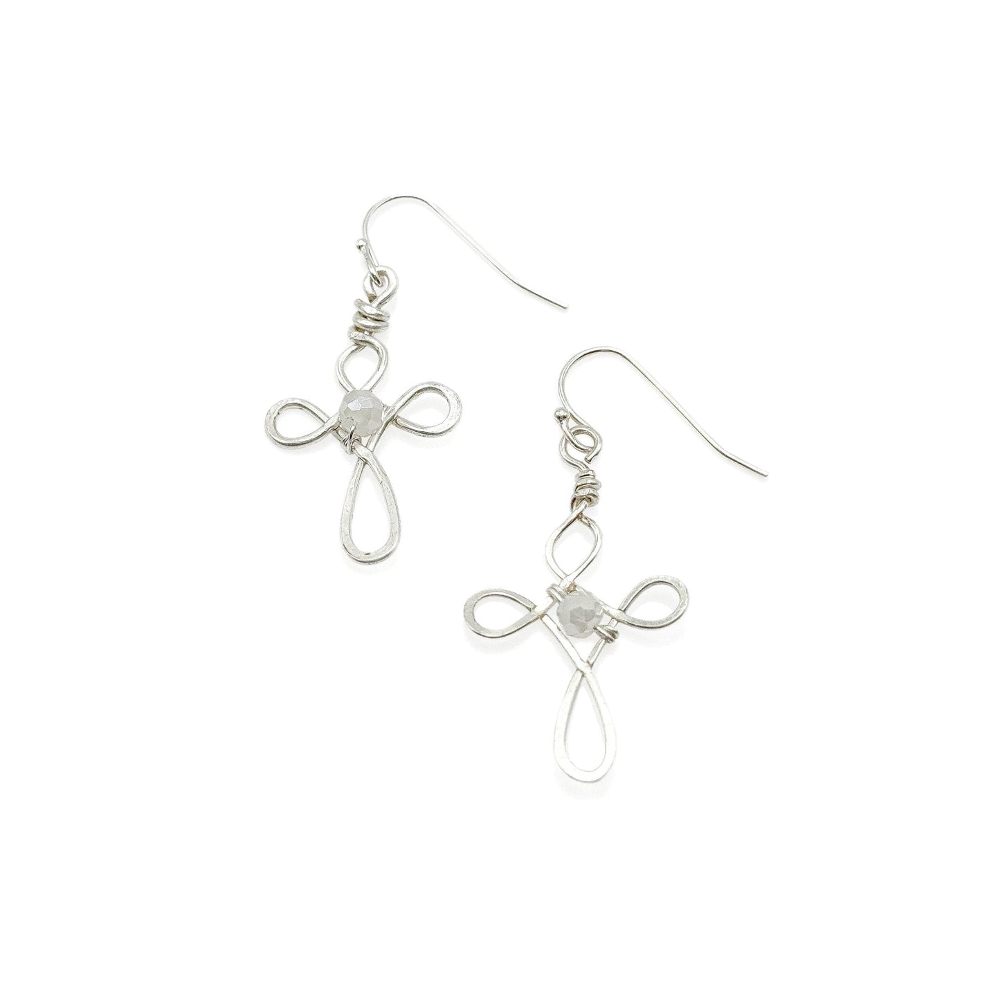 Silver cross-shaped earrings on a white background