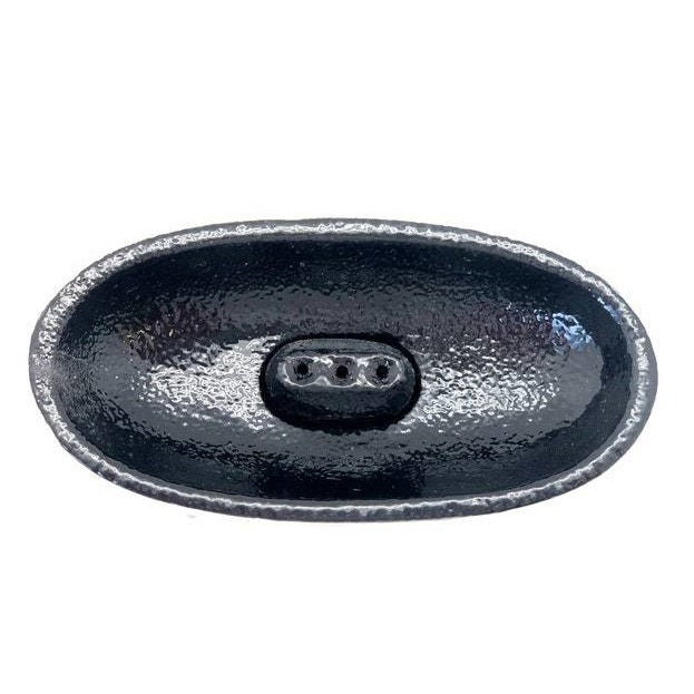 Black oval cast iron smudge pot on a white background