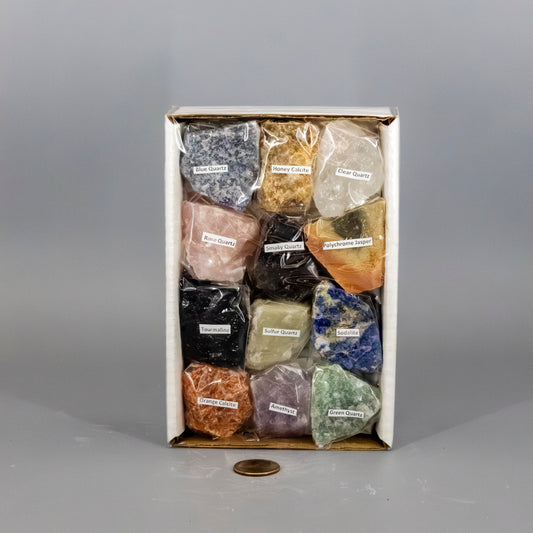 Box of various colored stones with labels on a gray background