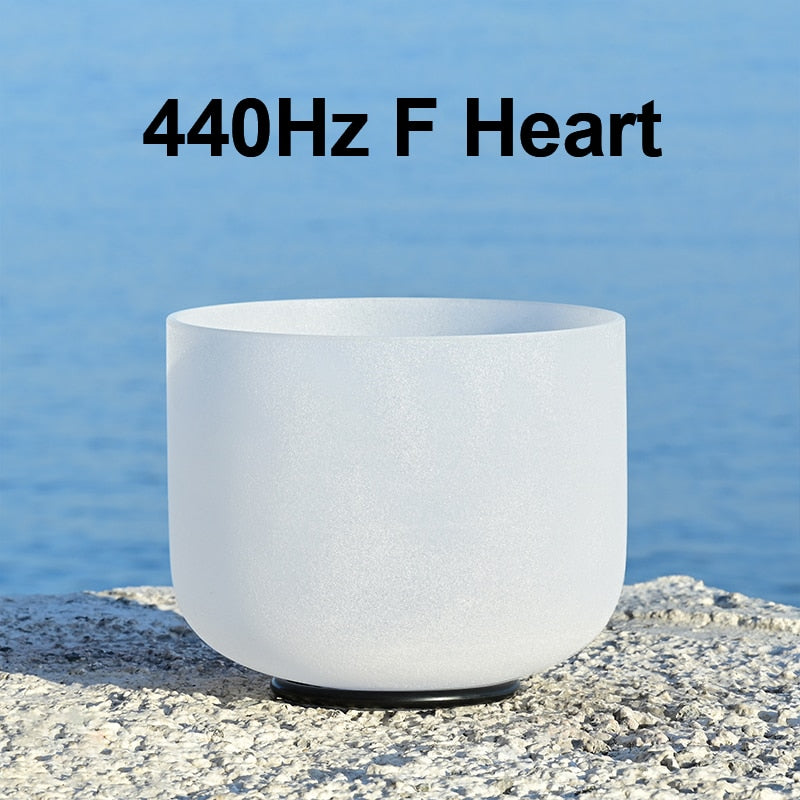 White singing bowl with '440Hz F Heart' text against a blue water background