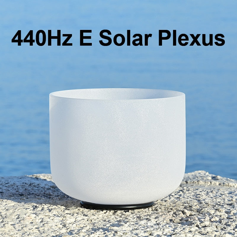White crystal singing bowl with text '440Hz E Solar Plexus' against a blue water background