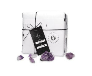 White gift box with purple crystals on a white background
