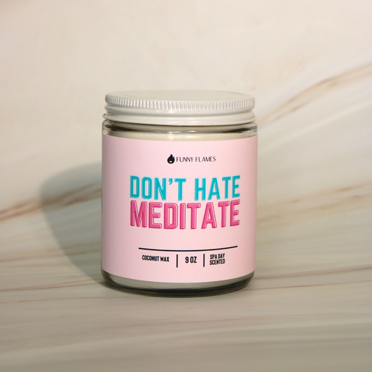 Candle jar with pink label reading 'Don't Hate Meditate' on a neutral background