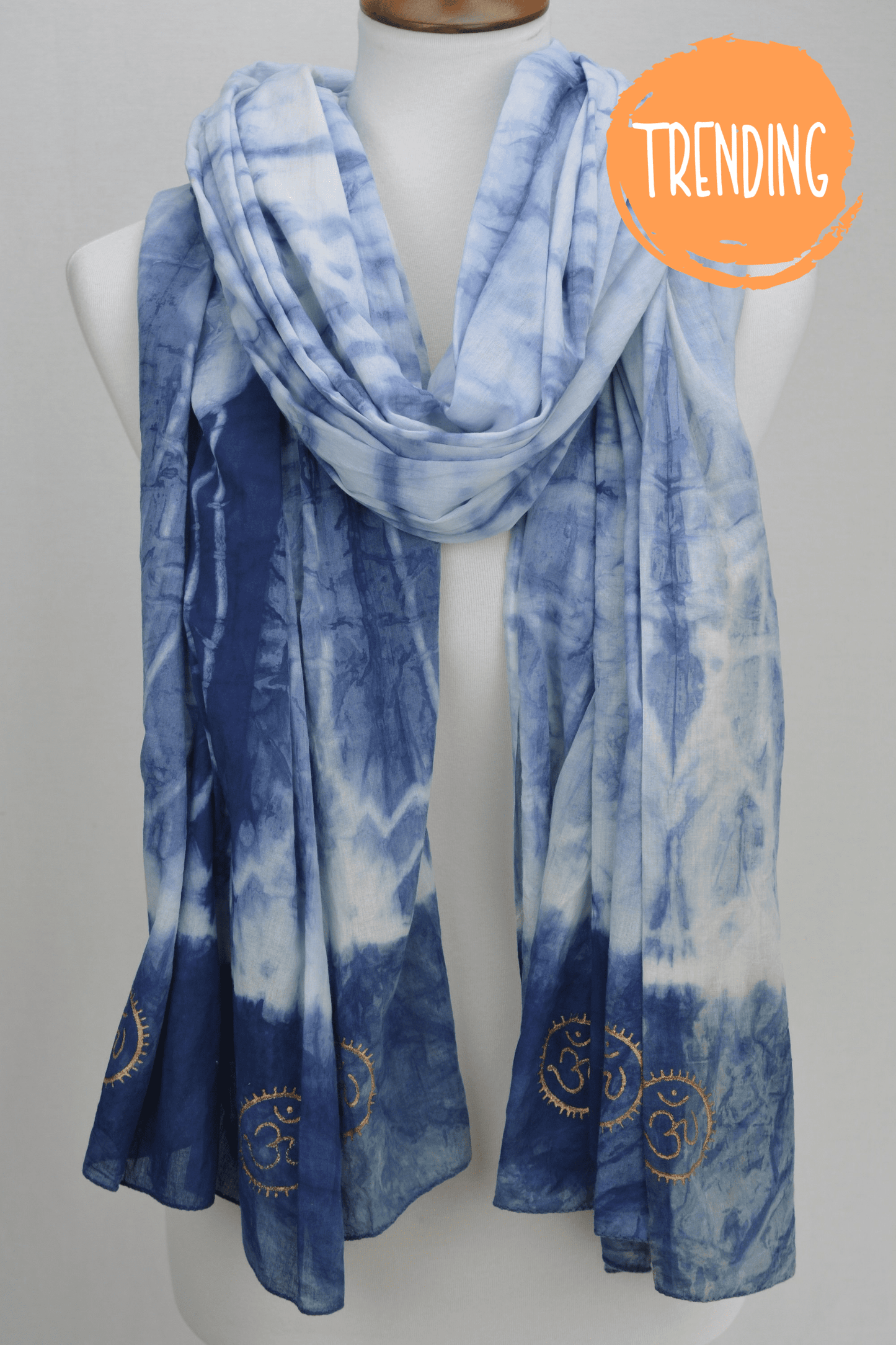Blue tie-dye scarf on a mannequin with 'Trending' label.