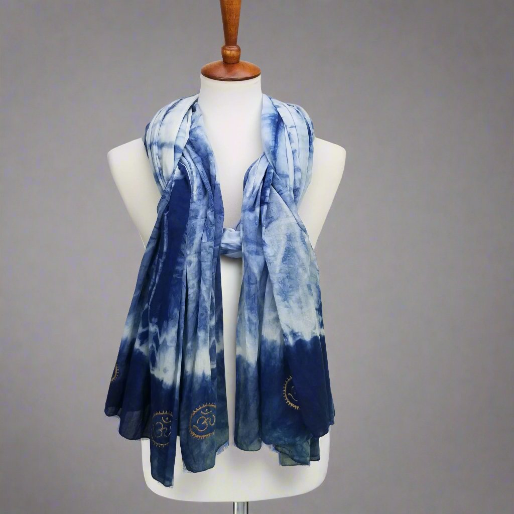 Blue tie-dye scarf on a mannequin against a gray background