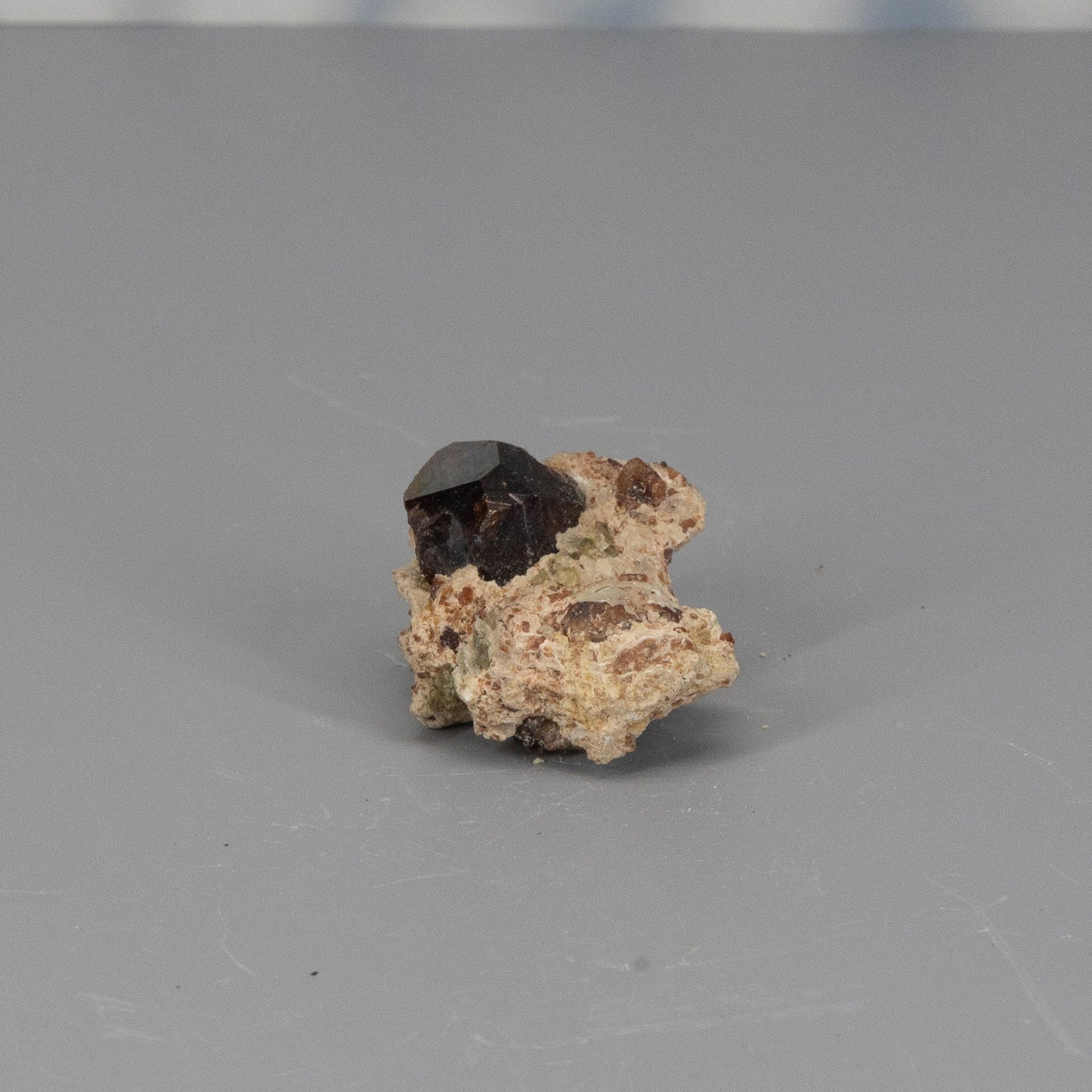 Garnet raw cluster on a gray background