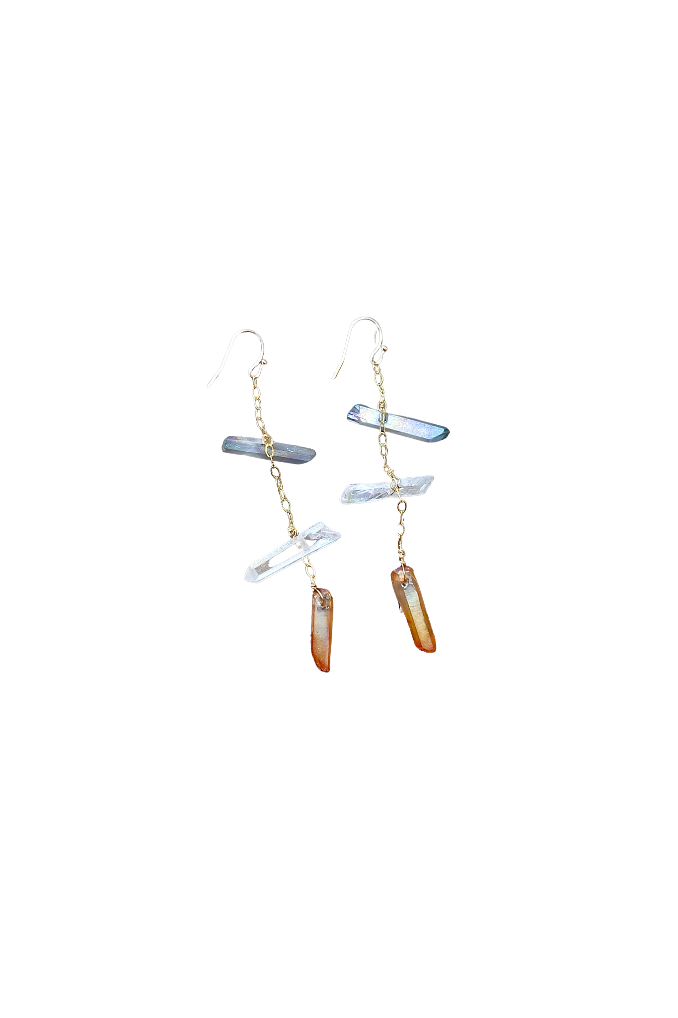 Pair of gold tone earrings with hanging quartz crystals on a white background