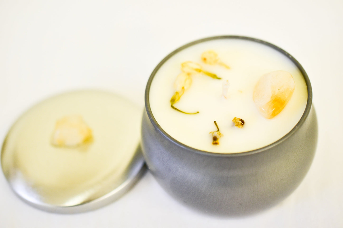 white candle and gold elements on a light background