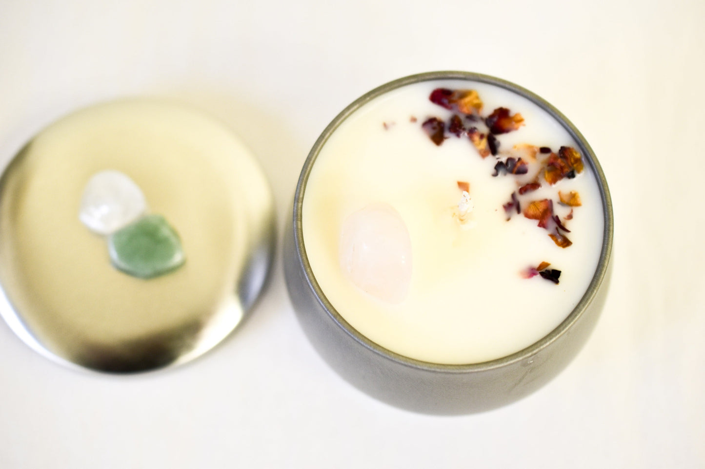 Ceramic container with a white candle and garnishes on a light background