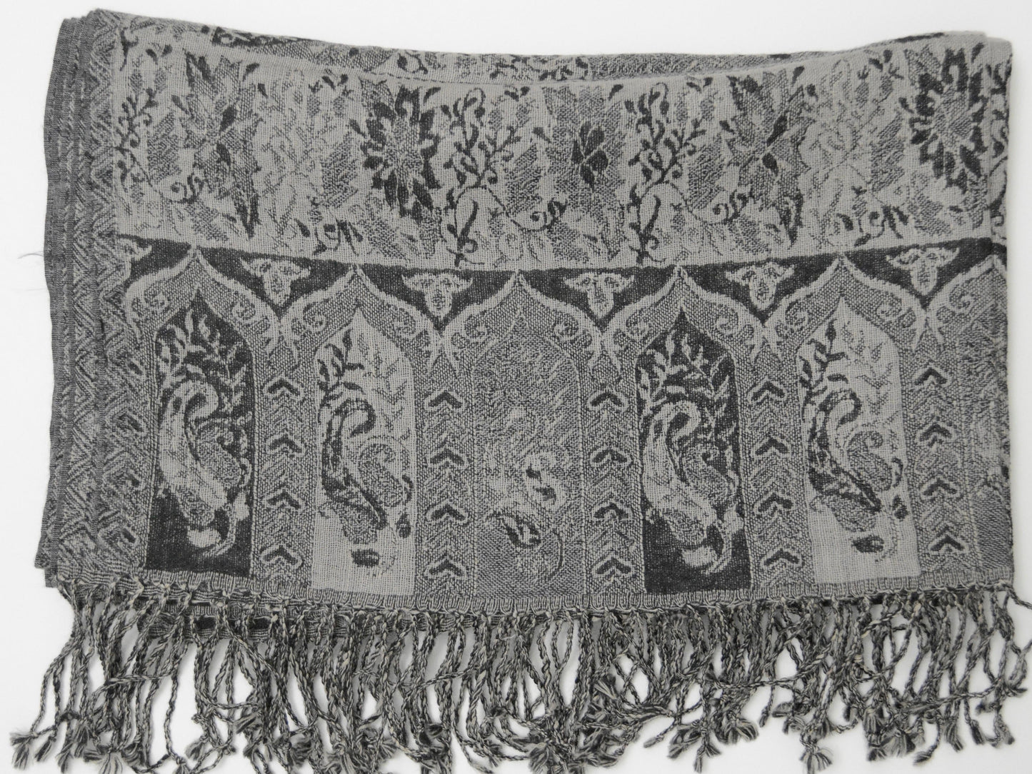 Textured shawl with paisley patterns and fringes on a white background