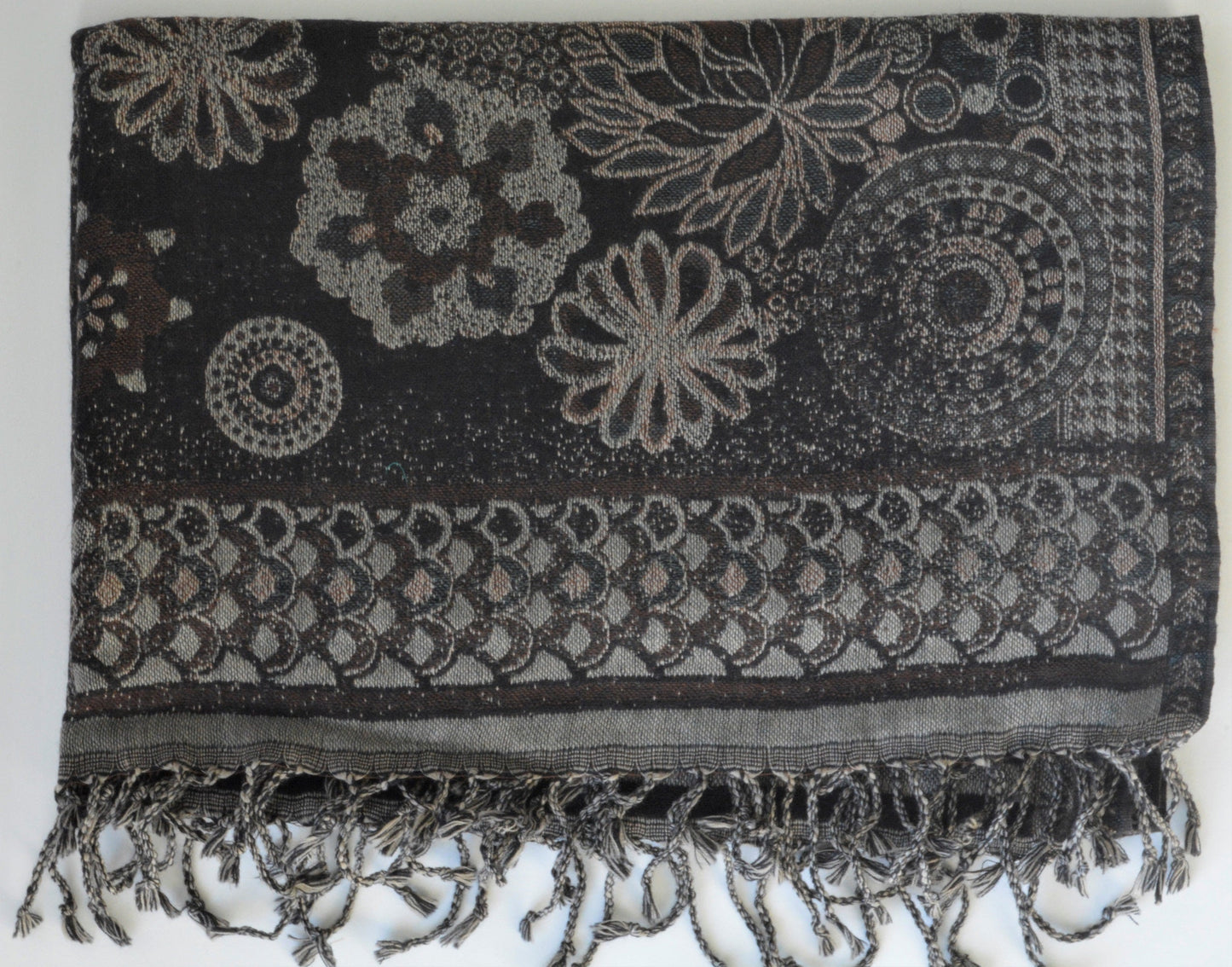 Black and gray patterned shawl with fringes on a white background