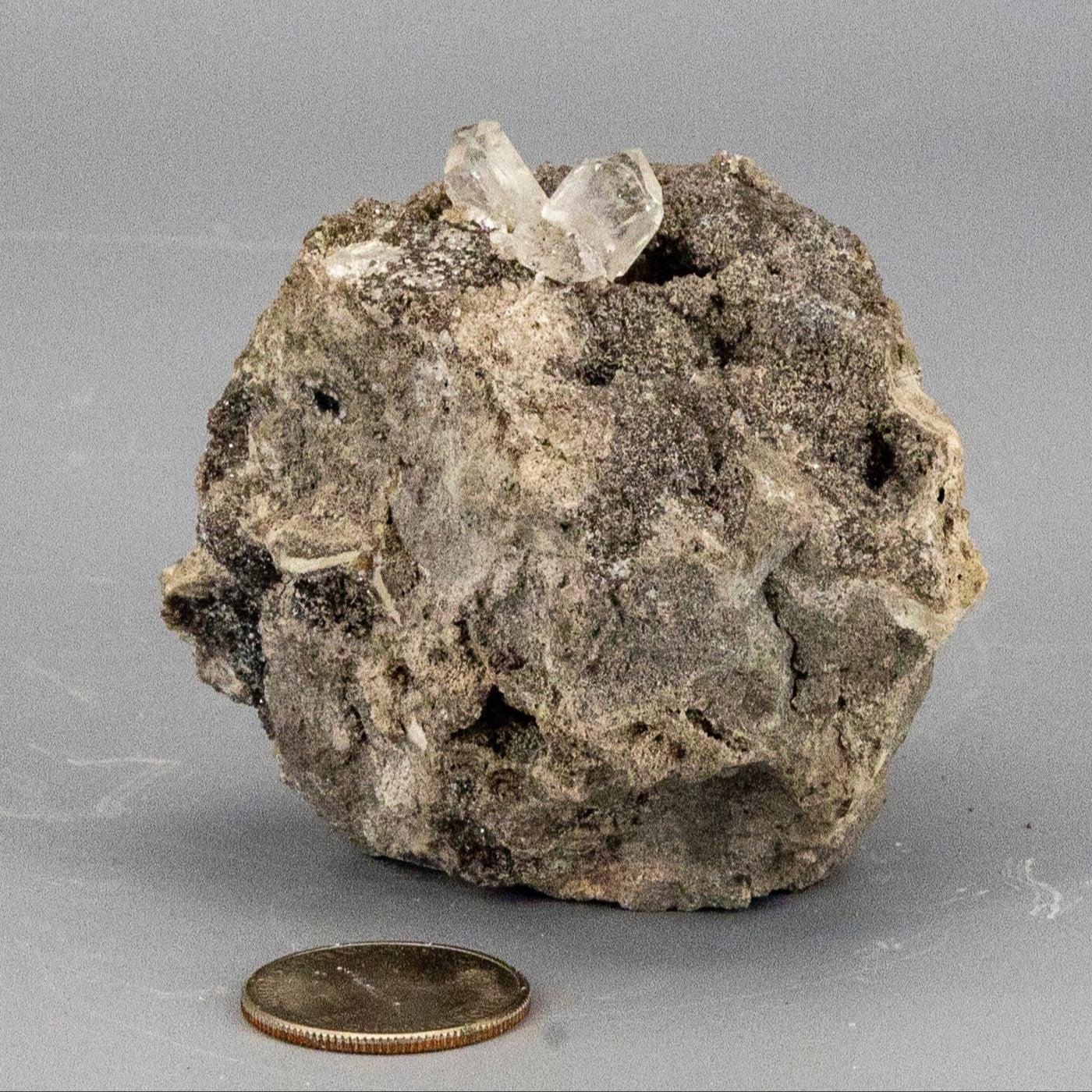 Mineral sample with herkimer diamond crystals on a gray background