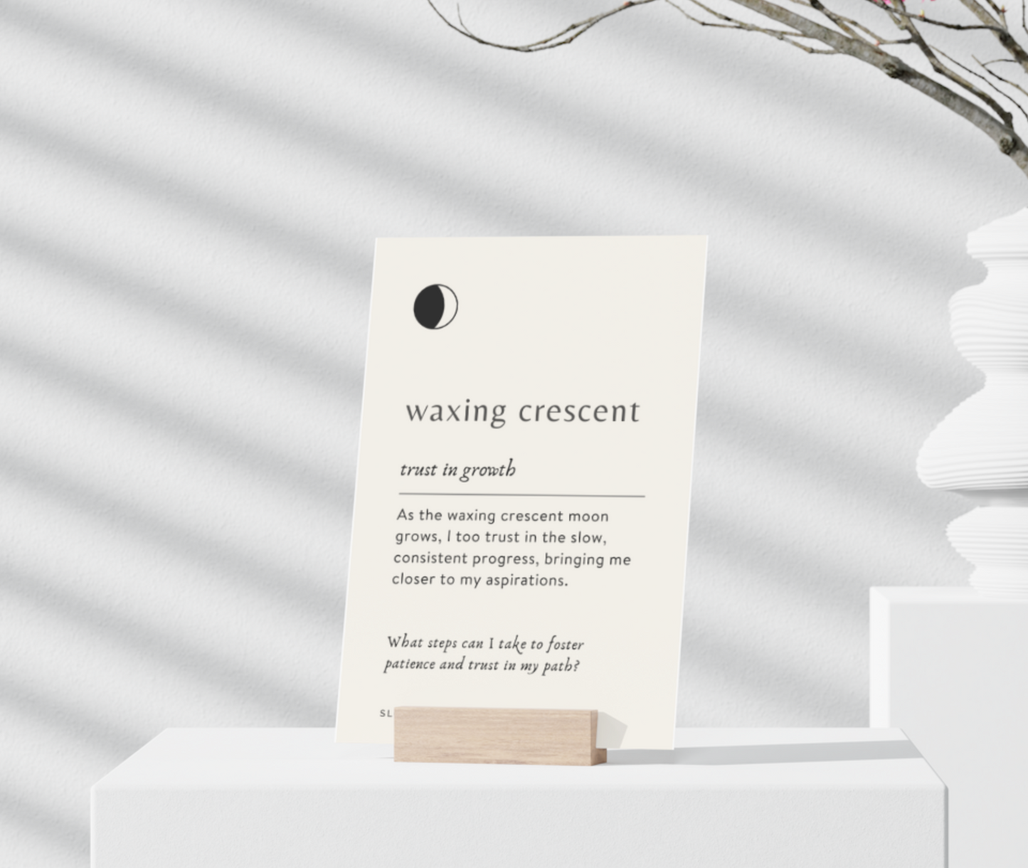 Card with text about the waxing crescent moon phase on a white surface