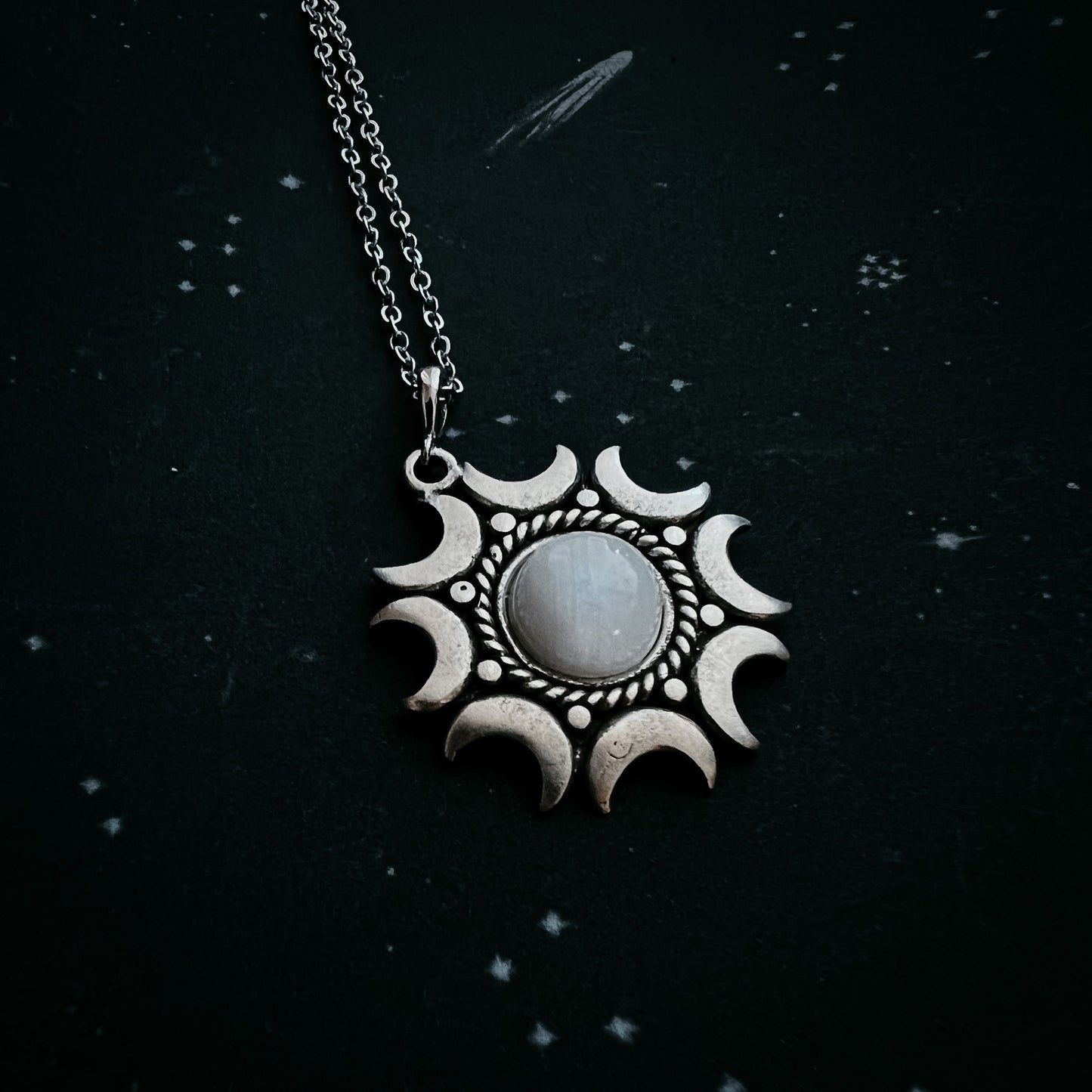 Necklace with a moonstone pendant on a dark background