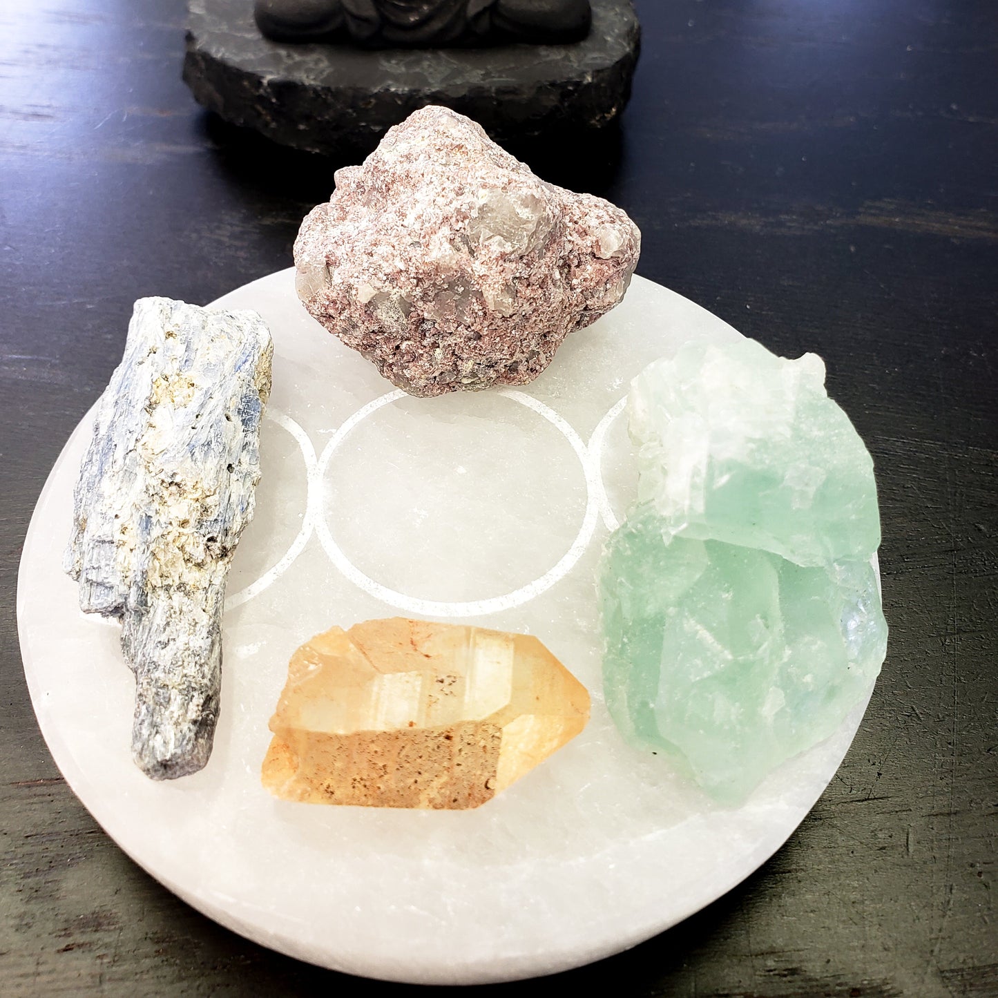 Collection of crystals on selenite with a dark background