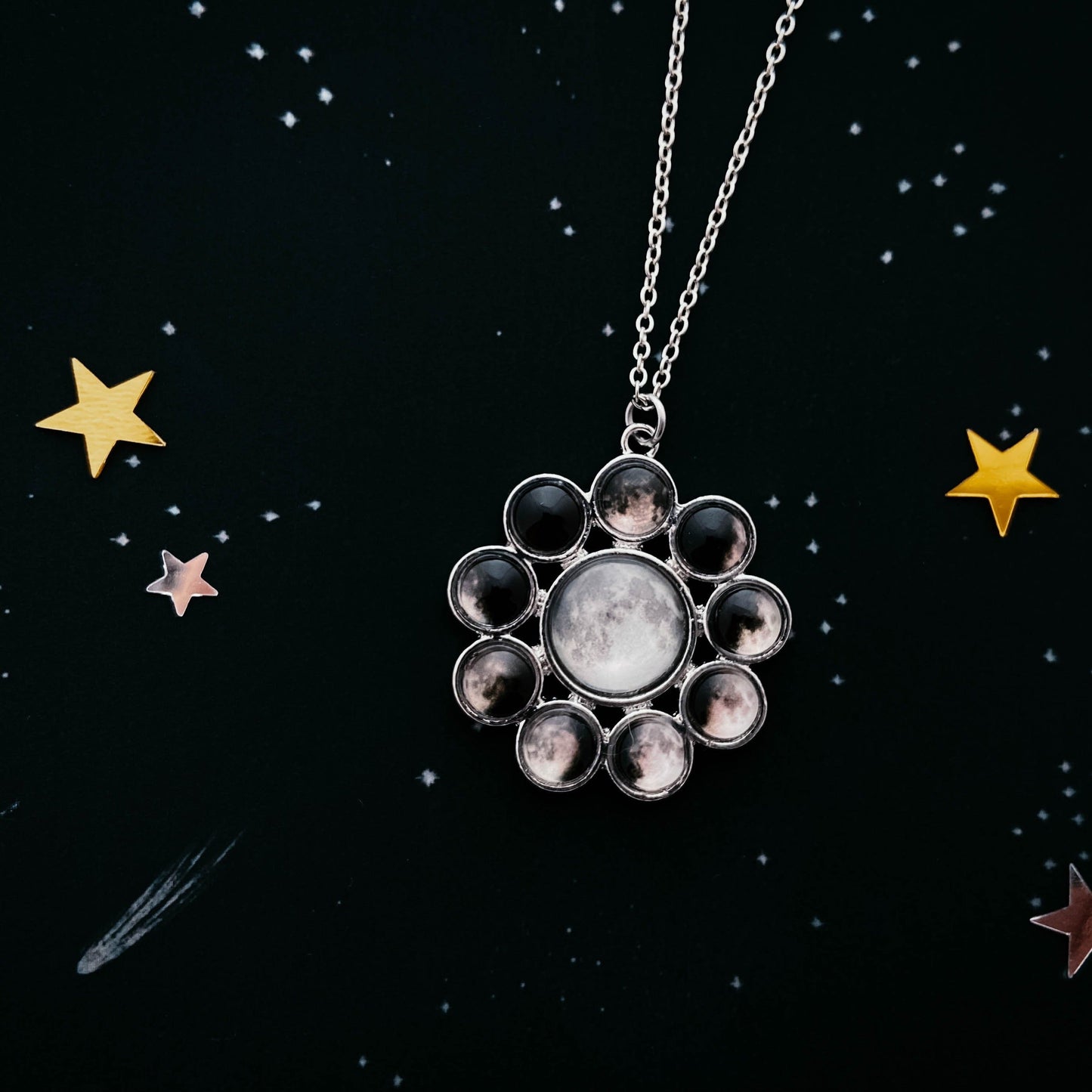 Necklace with a star-shaped pendant on a black background with stars