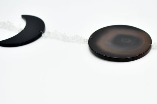 Close up of moon phase horizontal wall hanging on a white background