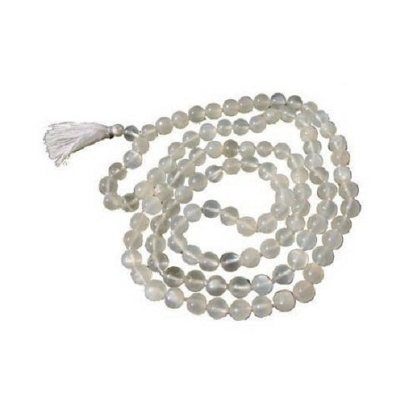 String of moonstone beads with a tassel on a white background
