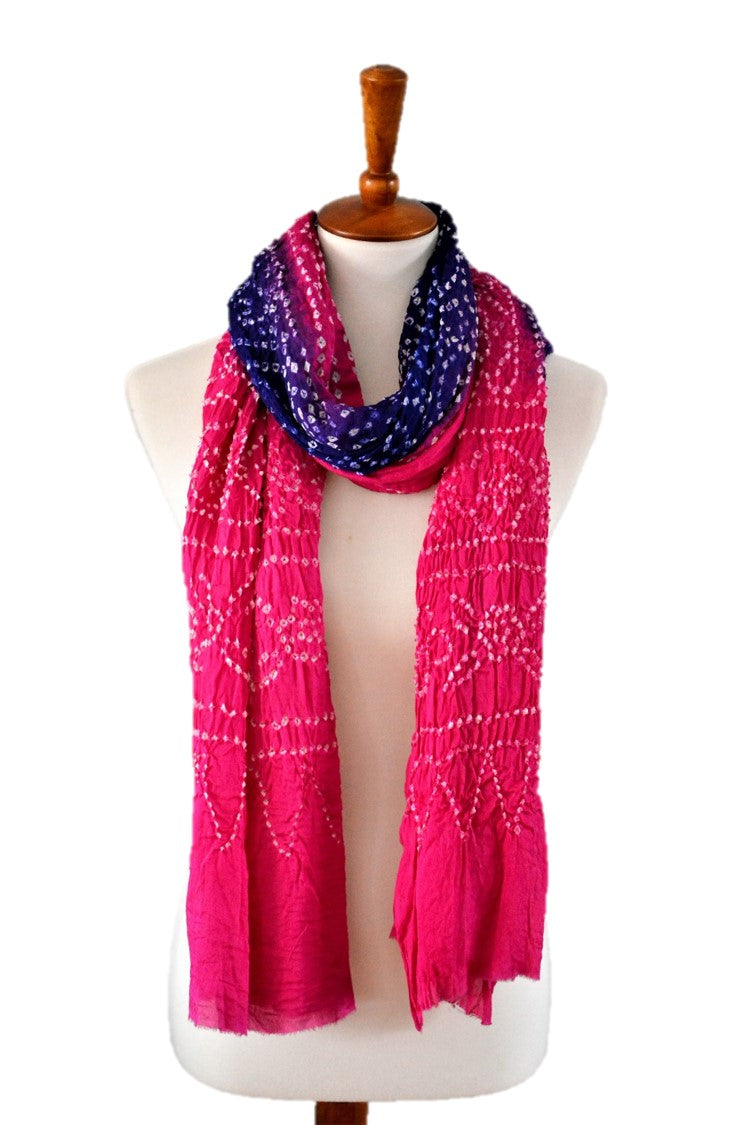 Mannequin wearing a pink and purple patterned silk scarf on a white background