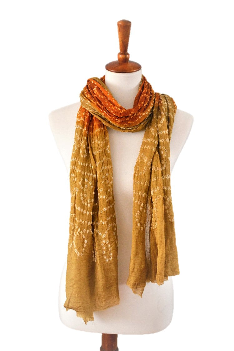 Mannequin wearing a mustard yellow silk scarf on a white background