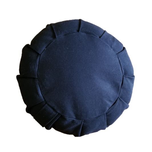 Round black cushion with pleated edges on a white background