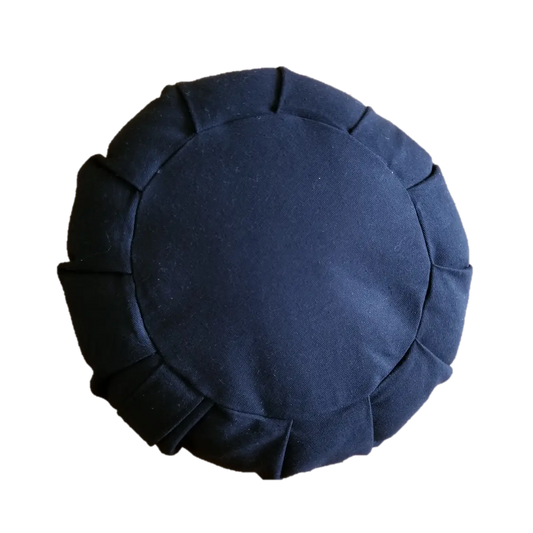 Round black cushion with pleated edges on a white background