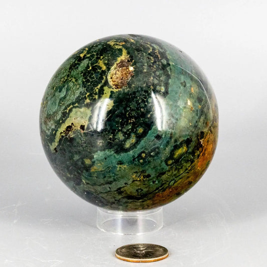 Decorative ocean jasper sphere with multicolored pattern on a white background