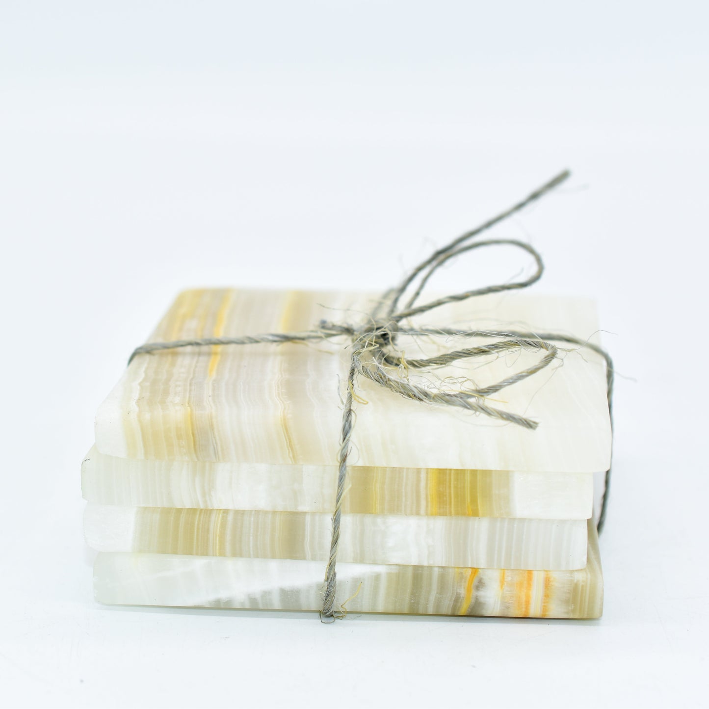 Packaged coasters with a ribbon on a white background