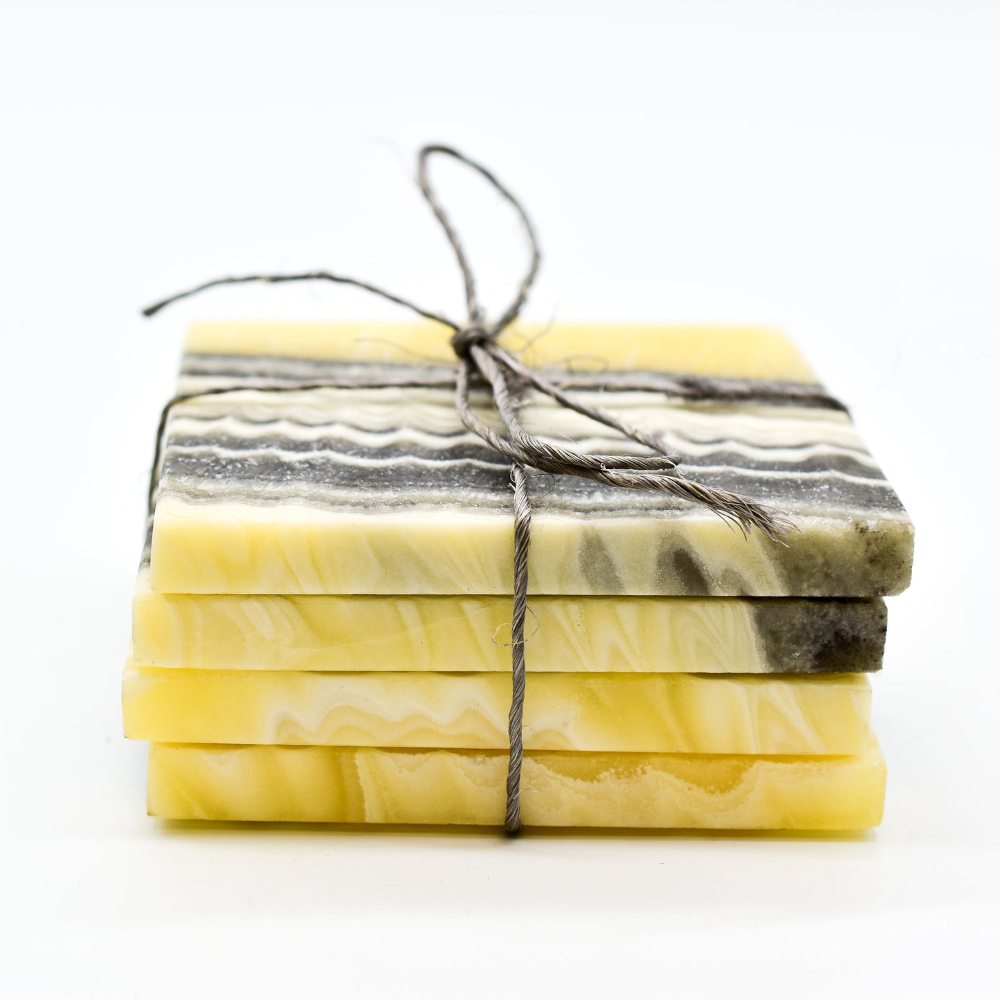 Stack of coasters tied with string on a white background