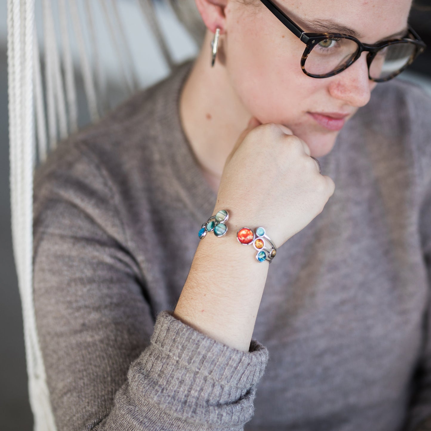 Person wearing a colorful bracelet on a blurred background
