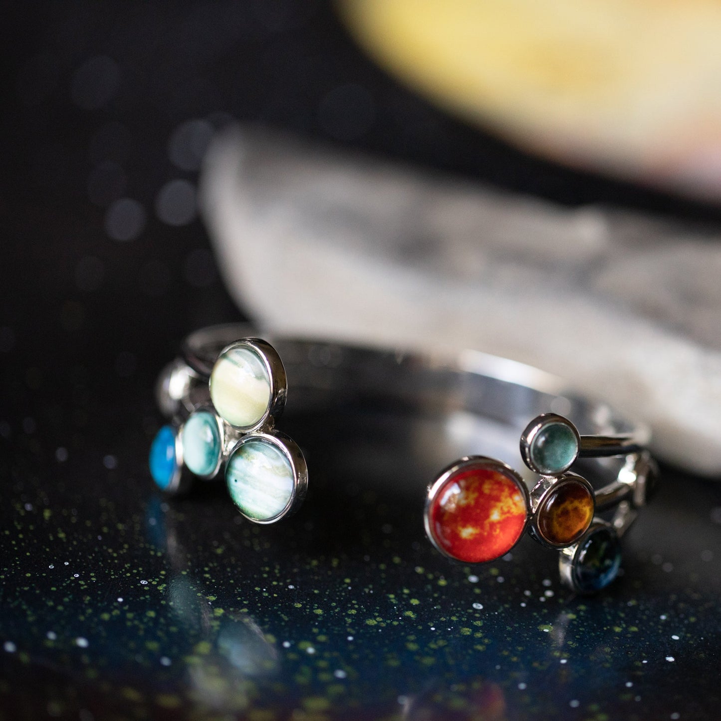 Silver bracelet with colorful gemstones on a dark surface