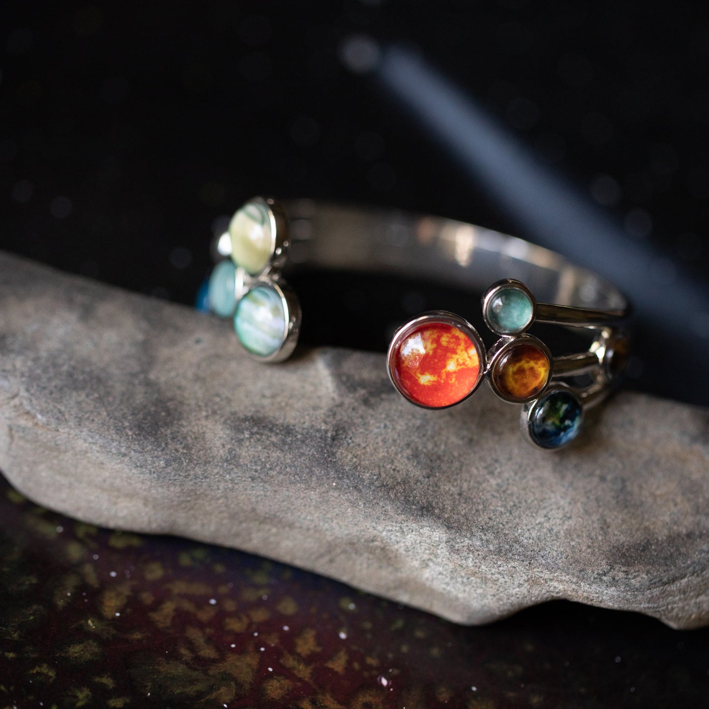 Colorful gemstone bracelet on a dark stone surface