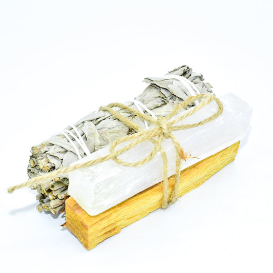 Bundled sage with palo santo and selenite on a white background