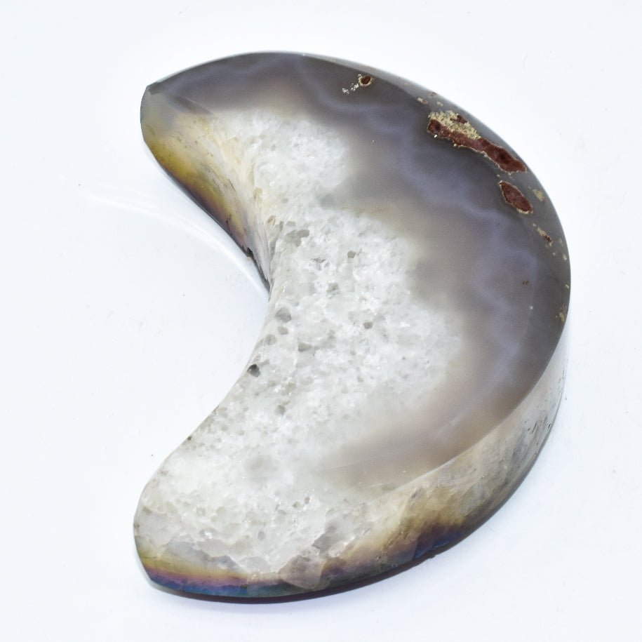 Half-moon shaped stone with a textured surface on a white background