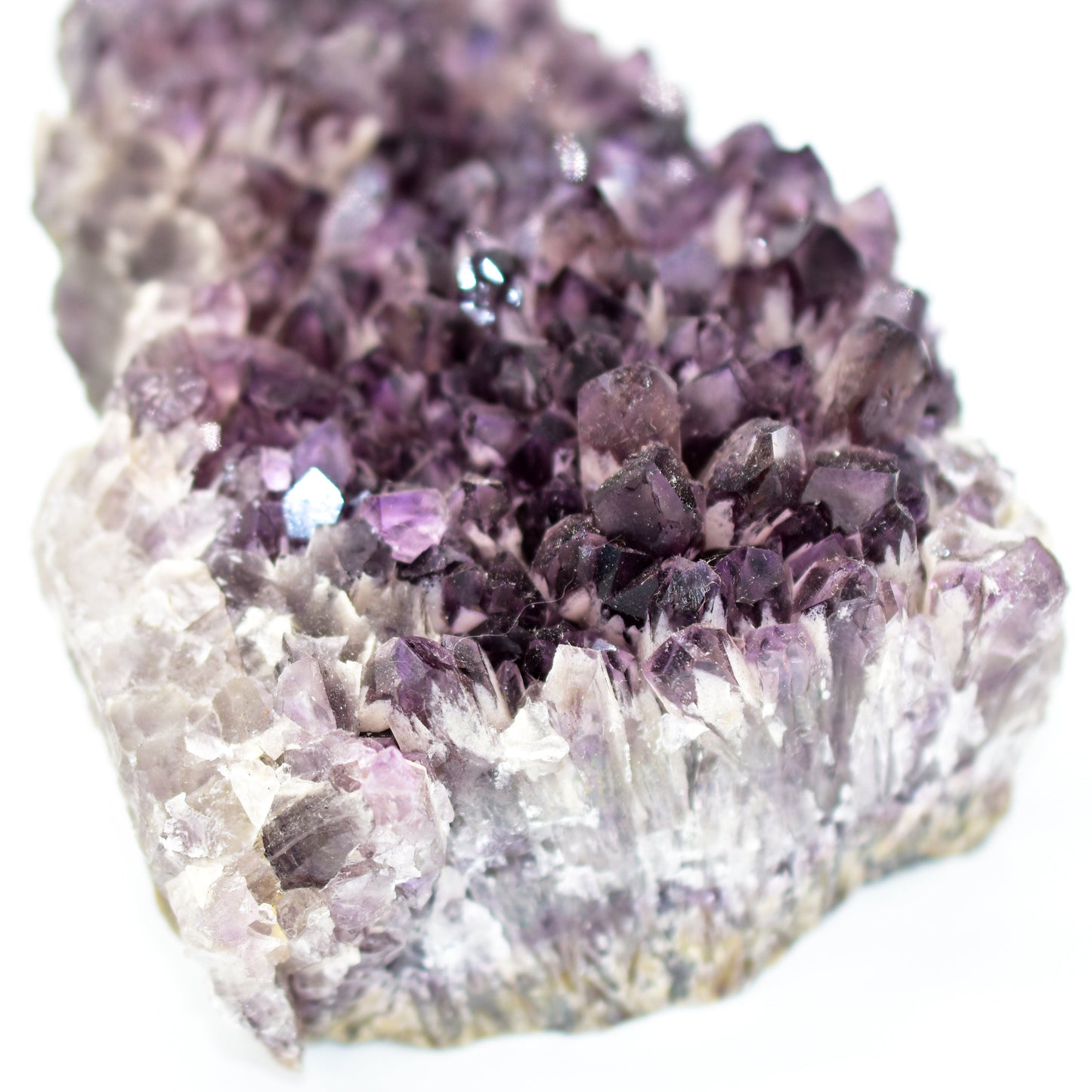 Close-up of a crystal formation with purple crystals on a white background