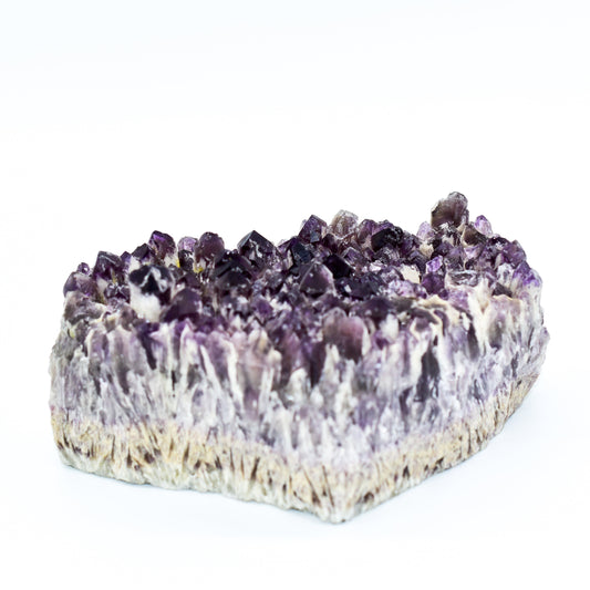 Amethyst crystal formation on a white background