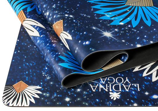 Yoga mat with starry night design and floral patterns.