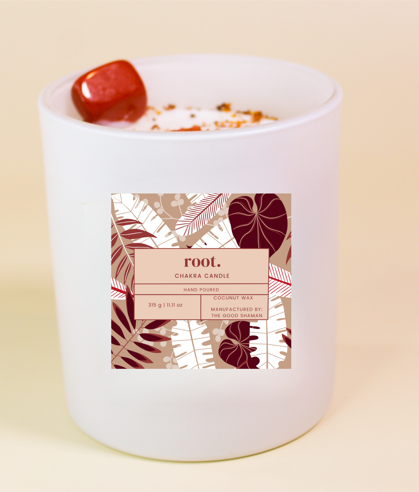 Root Chakra Candle with a decorative label on a beige background