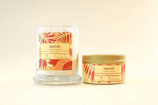 Two candles with 'sacral' branding on a beige background