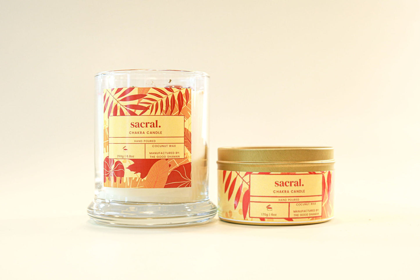 Two candles from the brand 'sacral' on a beige background