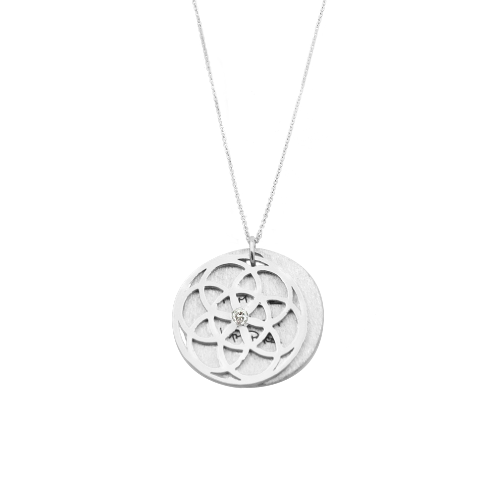 Silver necklace with a circular tree of life pendant on a white background