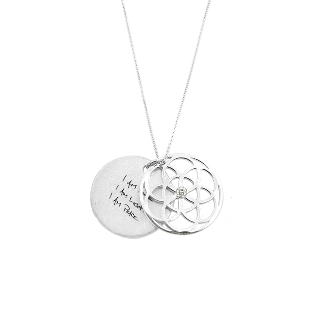 Silver necklace with two interlocking pendants on a white background