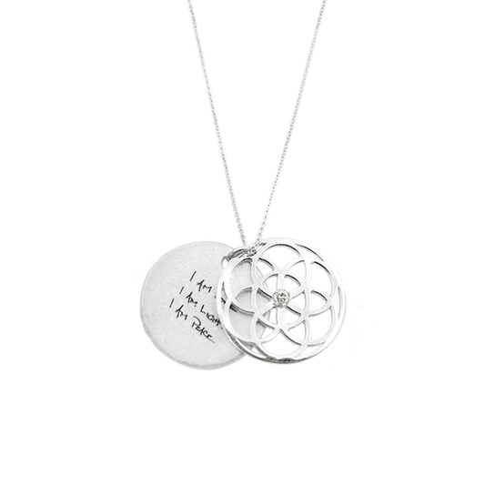 Silver necklace with two interlocking pendants on a white background