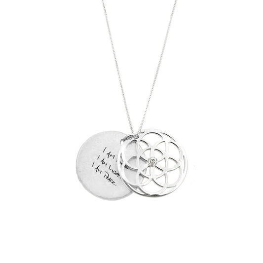 Silver necklace with two interlocking pendants on a white background