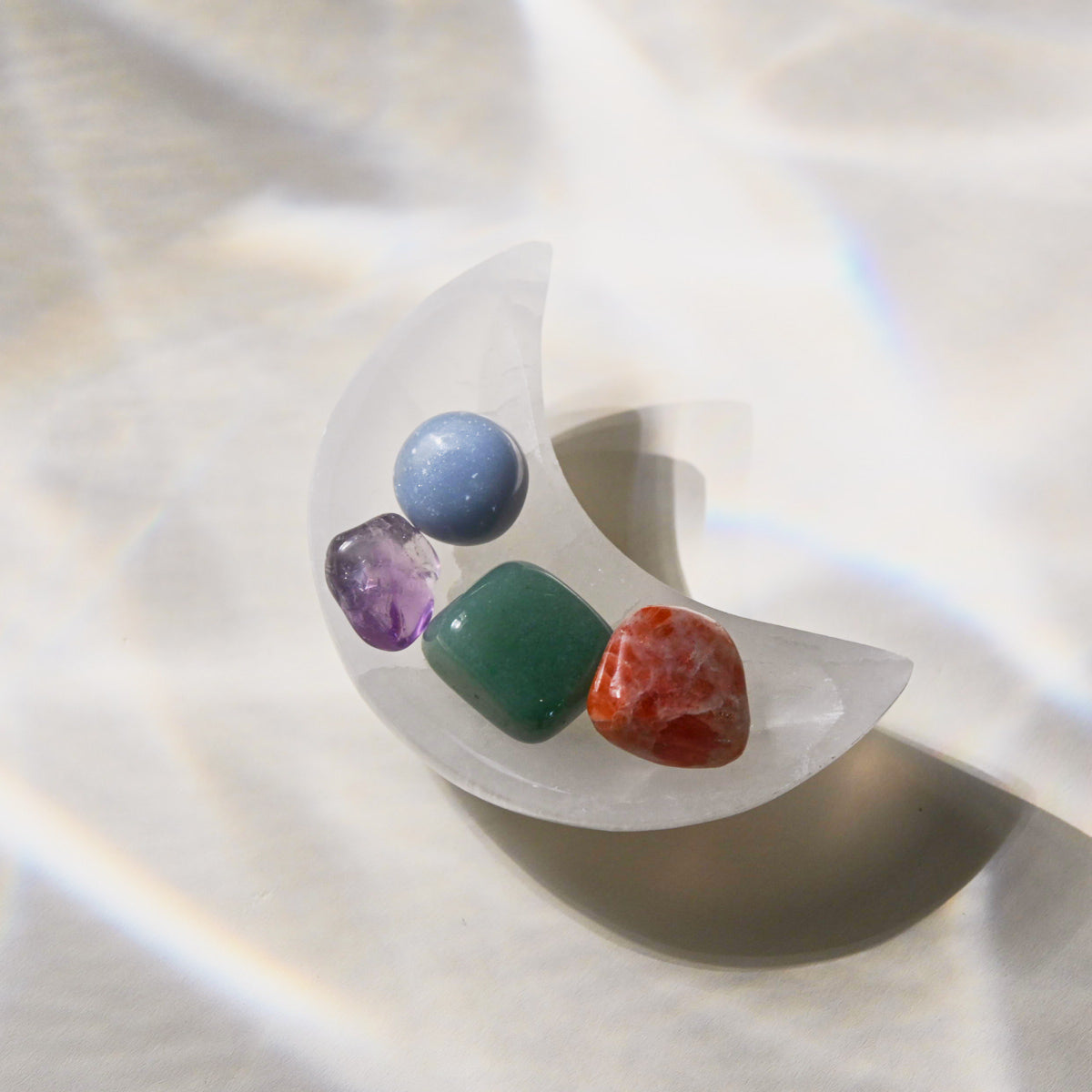 Clear stone ring with multicolored stones on a white background