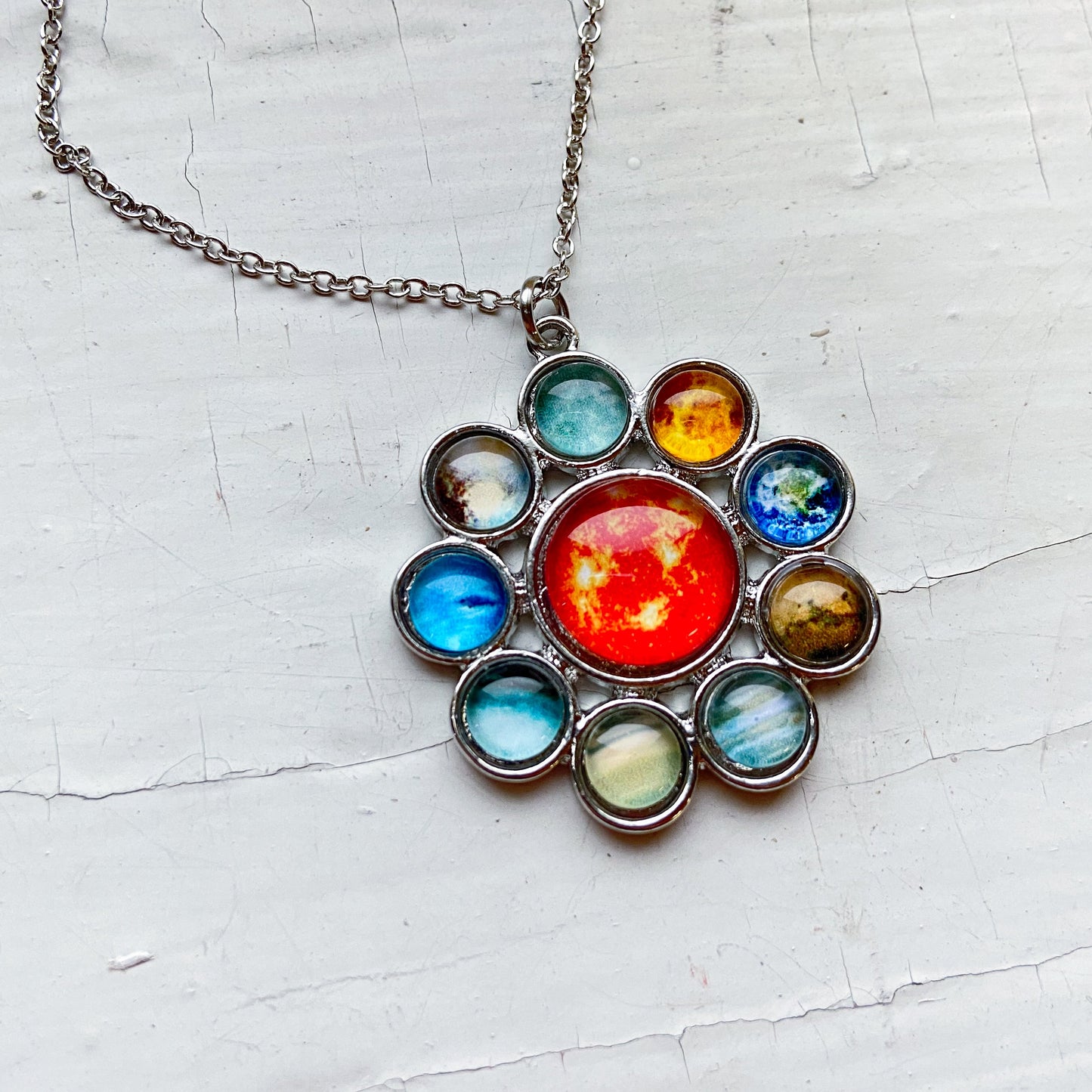 Necklace with a colorful pendant on a textured white background