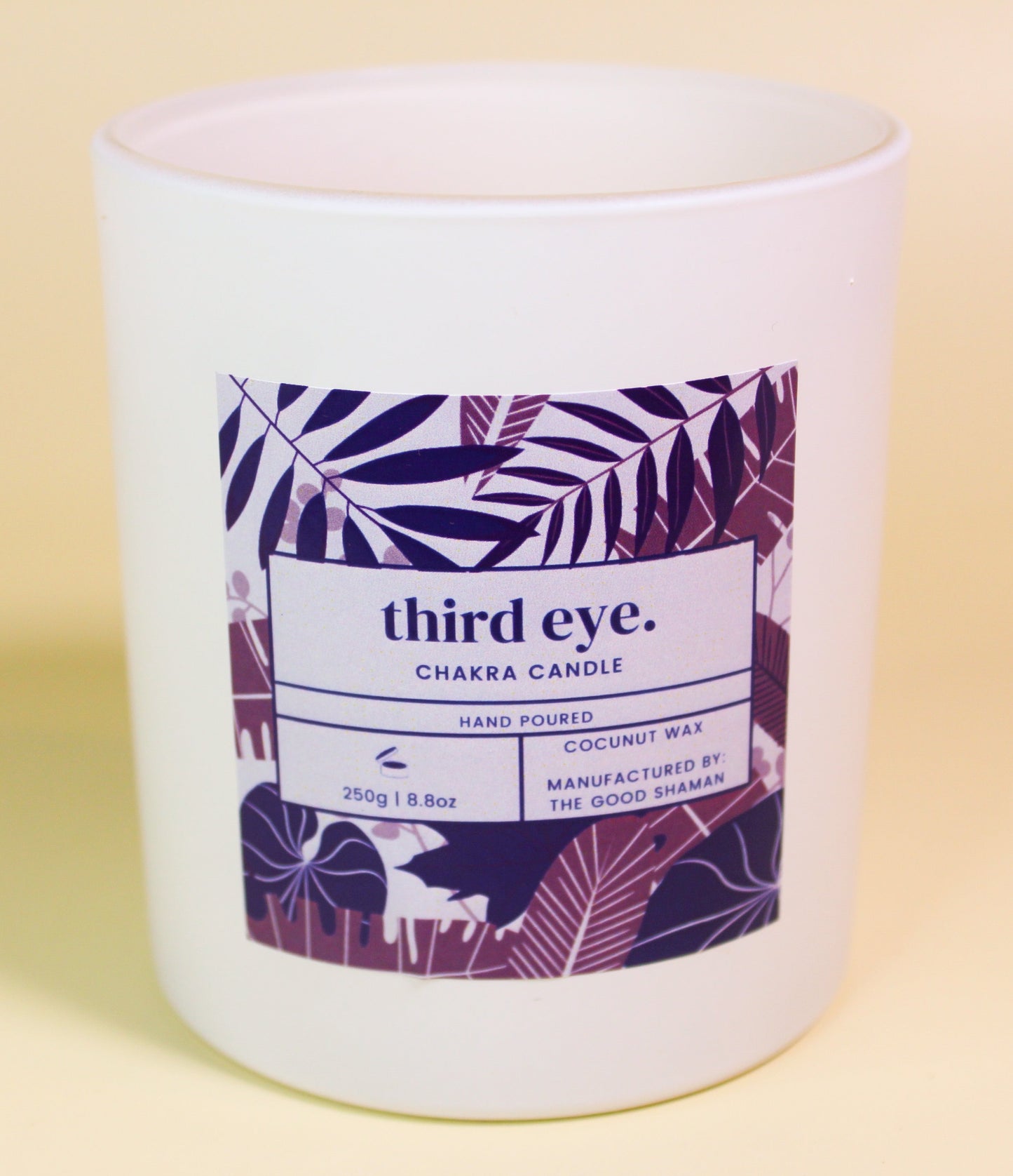 Candle with a label on a beige background