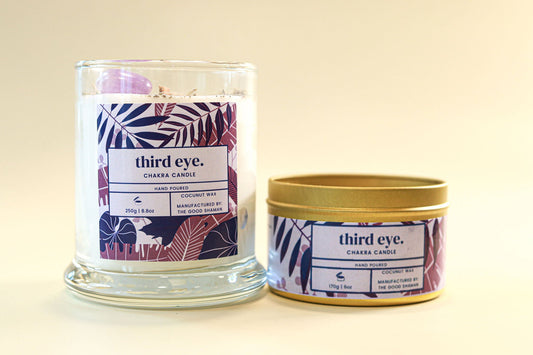 Two candles with 'third eye' branding on a beige background