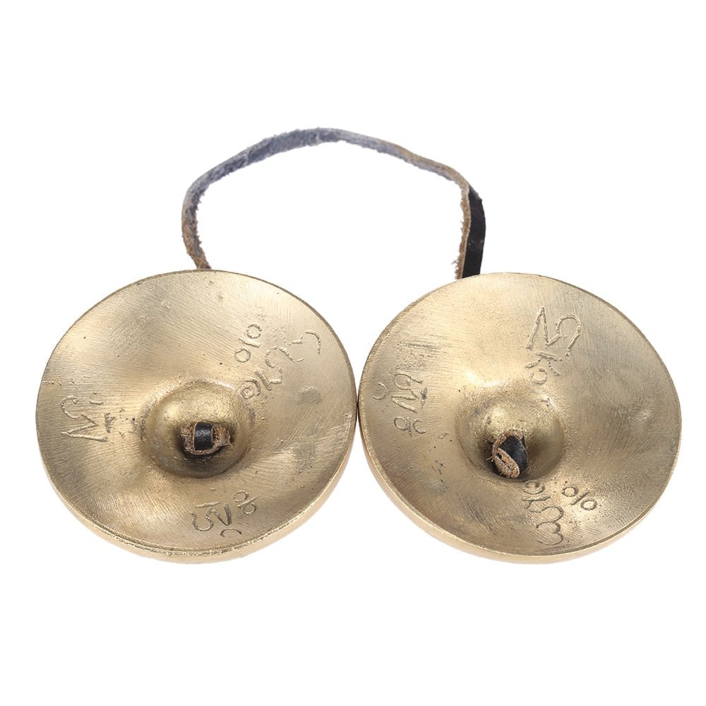 Pair of brass hand cymbals on a white background